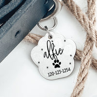 Thumbnail for Silver pawprint shaped pet tag joined to collar by two jump rings. Tag has a pawprint, animal name, phone number engraved on it.